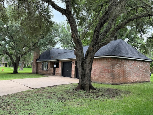 200 Wentworth Dr, West Columbia, TX 77486 - view of front of property with a garage, driveway, a front lawn, roof with shingles, and brick siding