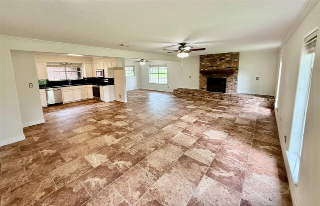 200 Wentworth Dr, West Columbia, TX 77486 - unfurnished living room featuring baseboards, ornamental molding, ceiling fan, a brick fireplace, and a sink
