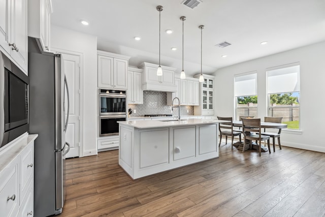 15003 Big Spring Park Dr, Cypress, TX 77433 - kitchen with stainless steel appliances, light countertops, white cabinetry, backsplash, and dark wood-type flooring
