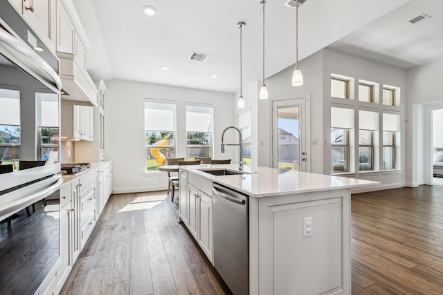 15003 Big Spring Park Dr, Cypress, TX 77433 - kitchen featuring appliances with stainless steel finishes, dark wood-style flooring, white cabinetry, and recessed lighting