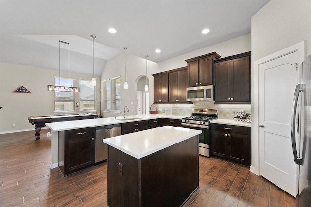17040 Shy Leaf Ct, Conroe, TX 77385 - kitchen featuring appliances with stainless steel finishes, a sink, a peninsula, light countertops, and dark brown cabinetry