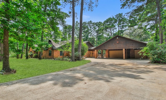 22402 Timber Ridge Dr, Magnolia, TX 77355 - view of front of home with a garage, a front lawn, brick siding, and concrete driveway