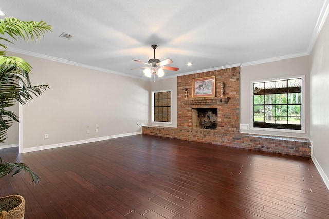 22402 Timber Ridge Dr, Magnolia, TX 77355 - unfurnished living room with ceiling fan, a brick fireplace, dark wood-style flooring, baseboards, and crown molding