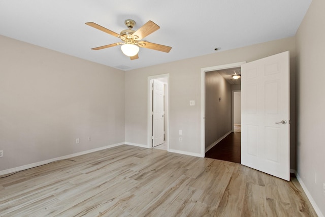 22402 Timber Ridge Dr, Magnolia, TX 77355 - unfurnished bedroom featuring light wood finished floors, attic access, a ceiling fan, and baseboards