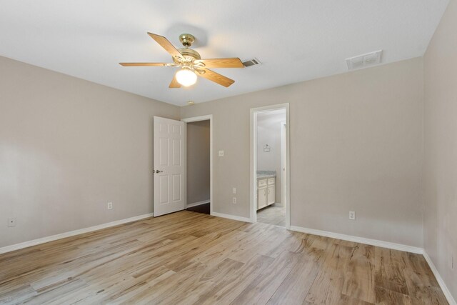 22402 Timber Ridge Dr, Magnolia, TX 77355 - unfurnished bedroom featuring light wood-style flooring, baseboards, connected bathroom, and ceiling fan