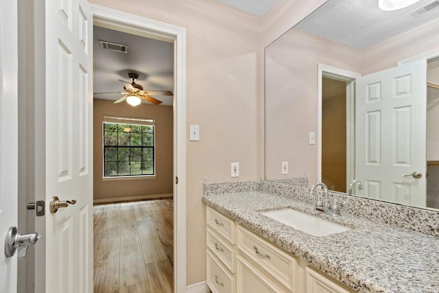 22402 Timber Ridge Dr, Magnolia, TX 77355 - bathroom featuring vanity, a ceiling fan, wood finished floors, and baseboards