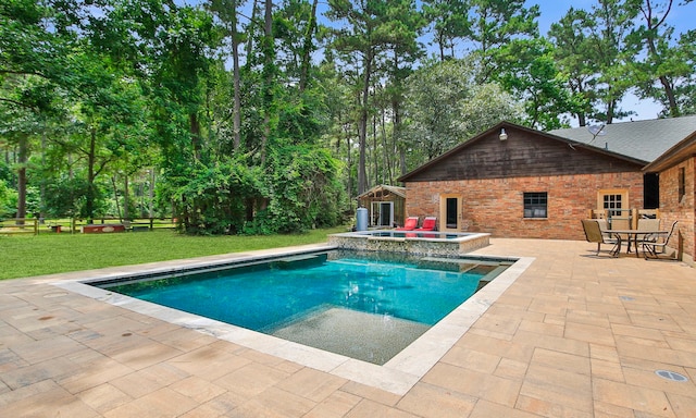 22402 Timber Ridge Dr, Magnolia, TX 77355 - view of swimming pool with a patio area, a pool with connected hot tub, and an outbuilding