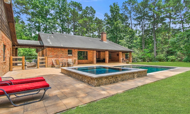 22402 Timber Ridge Dr, Magnolia, TX 77355 - view of pool featuring a patio, a lawn, and a pool with connected hot tub