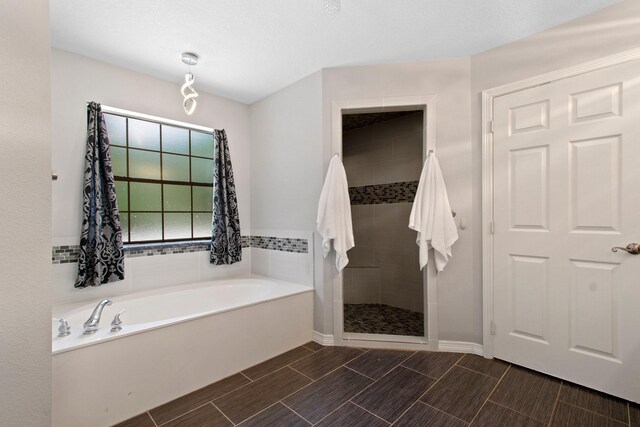22402 Timber Ridge Dr, Magnolia, TX 77355 - full bathroom with a bath, a stall shower, wood tiled floors, and baseboards