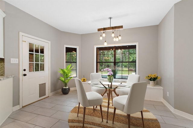 22402 Timber Ridge Dr, Magnolia, TX 77355 - dining area featuring light tile patterned floors, a chandelier, and baseboards