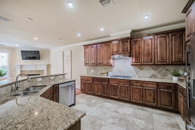 231 W 26th St, Houston, TX 77008 - kitchen with a sink, appliances with stainless steel finishes, crown molding, light stone countertops, and recessed lighting