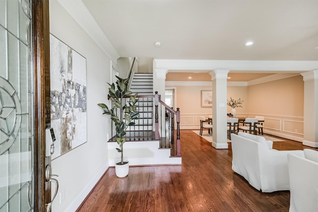 231 W 26th St, Houston, TX 77008 - entrance foyer featuring decorative columns, ornamental molding, stairs, wood finished floors, and a wainscoted wall