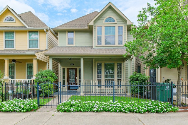231 W 26th St, Houston, TX 77008 - view of front facade featuring covered porch, a fenced front yard, and roof with shingles
