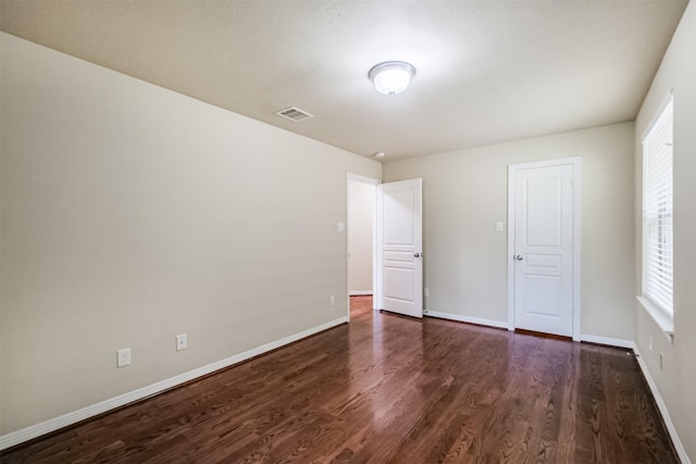 231 W 26th St, Houston, TX 77008 - unfurnished bedroom featuring dark wood-style flooring and baseboards
