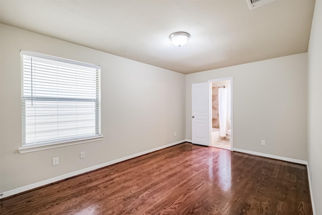 231 W 26th St, Houston, TX 77008 - empty room featuring wood finished floors, plenty of natural light, and baseboards
