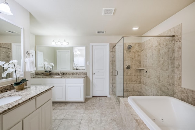 231 W 26th St, Houston, TX 77008 - full bathroom with a stall shower, a tub with jets, two vanities, and tile patterned floors