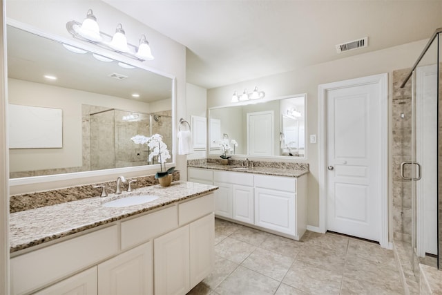 231 W 26th St, Houston, TX 77008 - full bath featuring a shower stall, two vanities, and tile patterned flooring