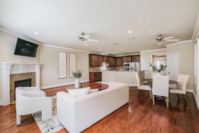 231 W 26th St, Houston, TX 77008 - living area with a ceiling fan, baseboards, recessed lighting, wood finished floors, and crown molding