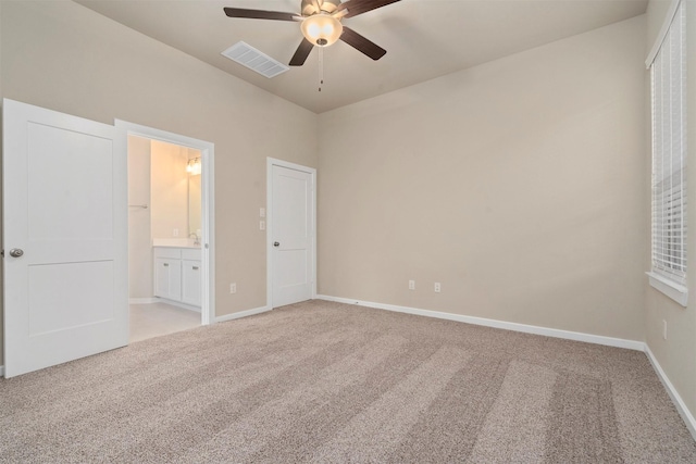 119 Lukewood Cir, Conroe, TX 77318 - unfurnished bedroom featuring light carpet, baseboards, and connected bathroom
