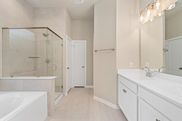 119 Lukewood Cir, Conroe, TX 77318 - full bathroom featuring a shower stall, a garden tub, double vanity, baseboards, and tile patterned flooring