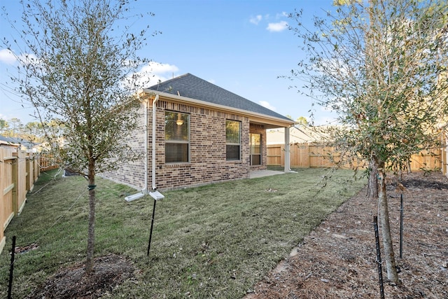 119 Lukewood Cir, Conroe, TX 77318 - back of property with brick siding, roof with shingles, and a patio