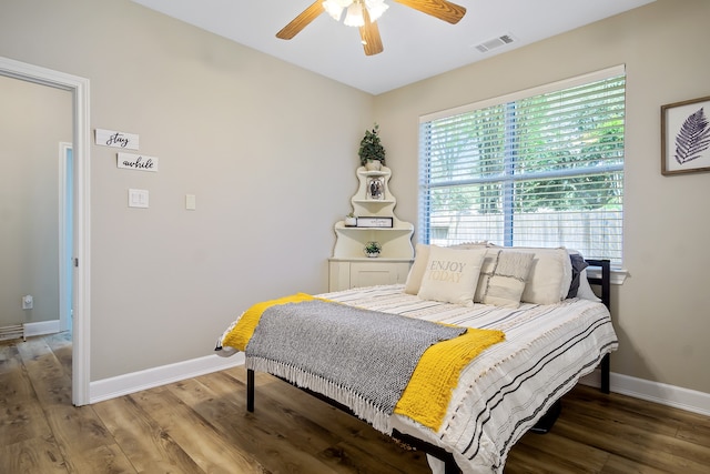 3006 Pecan Way Ct, Richmond, TX 77406 - bedroom with wood finished floors, baseboards, and a ceiling fan