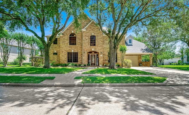 3006 Pecan Way Ct, Richmond, TX 77406 - traditional-style house with a front lawn, concrete driveway, brick siding, and a garage