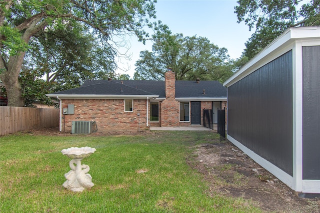822 Red Rock Canyon Dr, Katy, TX 77450 - back of property featuring a chimney, a patio area, brick siding, and a shingled roof