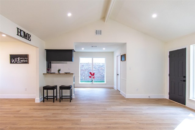 822 Red Rock Canyon Dr, Katy, TX 77450 - kitchen featuring beam ceiling, a breakfast bar area, light wood finished floors, recessed lighting, and high vaulted ceiling