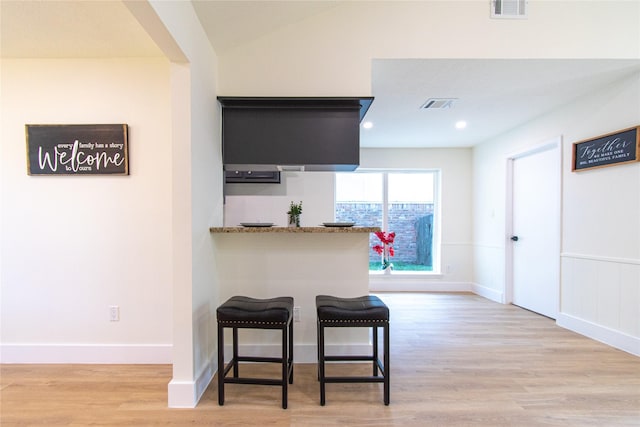 822 Red Rock Canyon Dr, Katy, TX 77450 - kitchen with wood finished floors, a kitchen breakfast bar, and recessed lighting