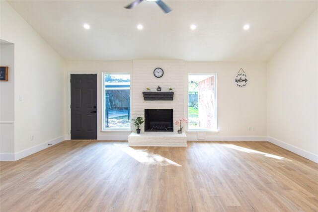 822 Red Rock Canyon Dr, Katy, TX 77450 - unfurnished living room with ceiling fan, light wood-type flooring, a fireplace, recessed lighting, and vaulted ceiling