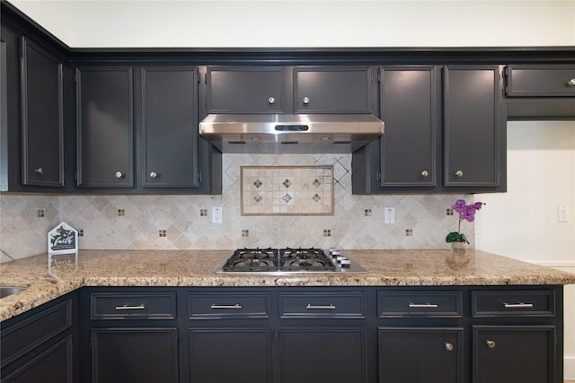 822 Red Rock Canyon Dr, Katy, TX 77450 - kitchen featuring under cabinet range hood, stainless steel gas stovetop, tasteful backsplash, and light stone counters