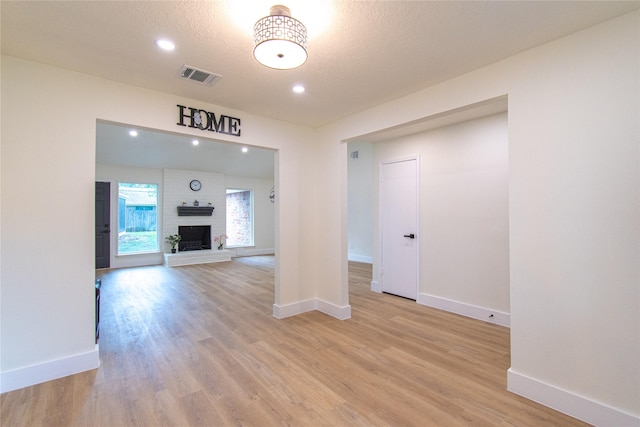 822 Red Rock Canyon Dr, Katy, TX 77450 - empty room featuring light wood-type flooring, recessed lighting, and a fireplace