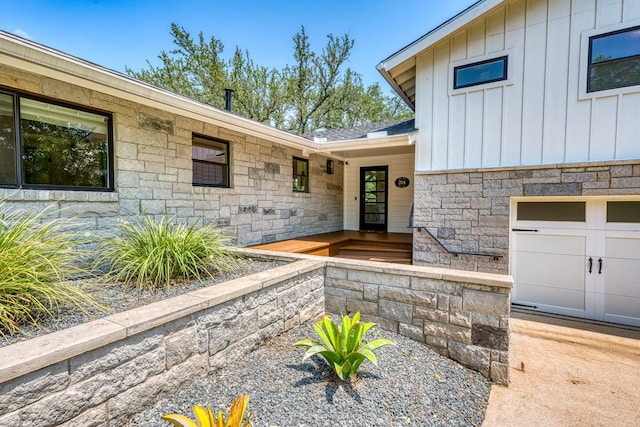 204 Blue Waters Dr, Horseshoe Bay, TX 78657 - property entrance featuring stone siding, board and batten siding, and an attached garage
