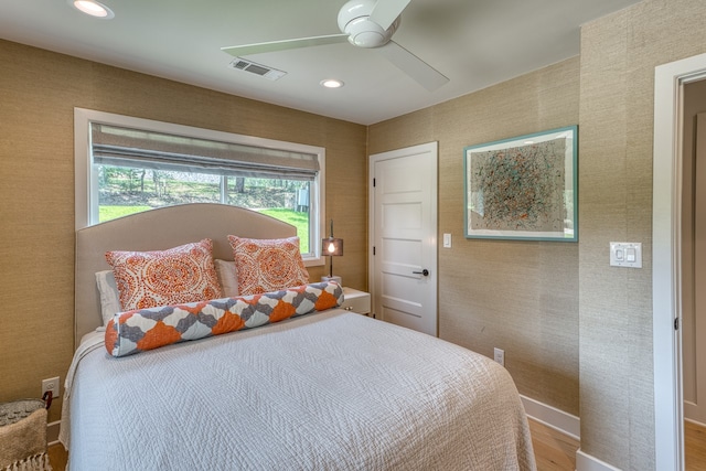 204 Blue Waters Dr, Horseshoe Bay, TX 78657 - bedroom featuring wood finished floors, recessed lighting, ceiling fan, and baseboards