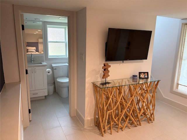 204 Blue Waters Dr, Horseshoe Bay, TX 78657 - bathroom with vanity, toilet, baseboards, and tile patterned floors