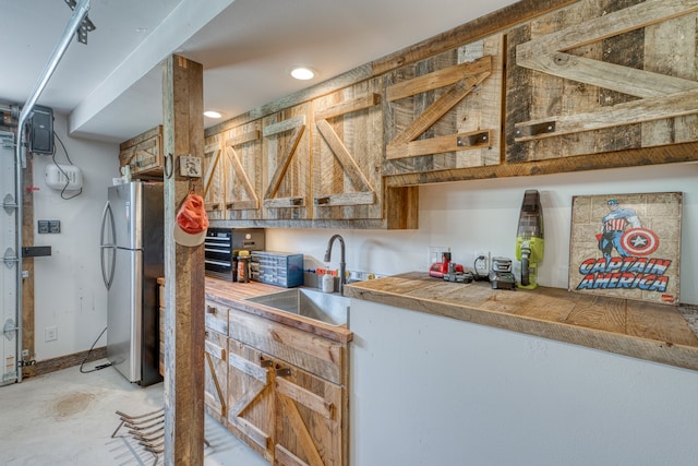 204 Blue Waters Dr, Horseshoe Bay, TX 78657 - kitchen with freestanding refrigerator, a sink, concrete flooring, and recessed lighting