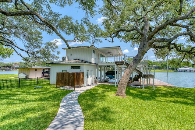 204 Blue Waters Dr, Horseshoe Bay, TX 78657 - back of house featuring a ceiling fan, a water view, metal roof, board and batten siding, and a standing seam roof