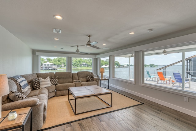 204 Blue Waters Dr, Horseshoe Bay, TX 78657 - living room with healthy amount of natural light, a ceiling fan, a water view, recessed lighting, and light wood-style flooring