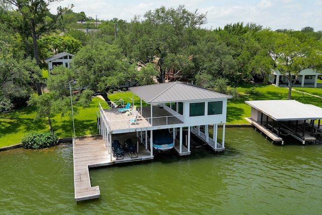204 Blue Waters Dr, Horseshoe Bay, TX 78657 - dock with boat lift, a water view, and view of wooded area