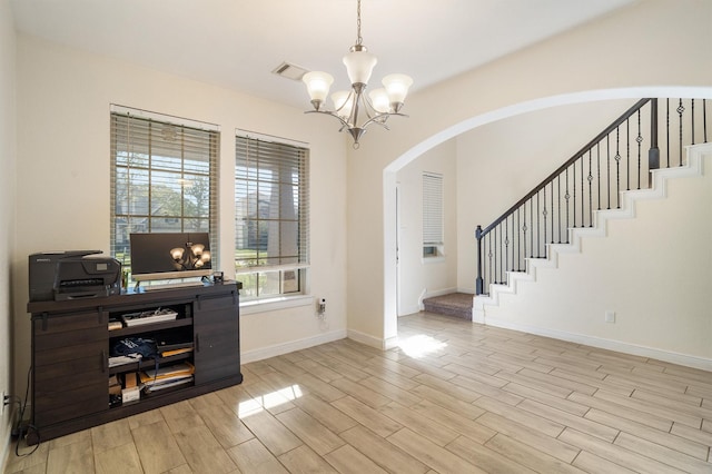 2715 Wembley Way, Rosenberg, TX 77471 - entrance foyer featuring a chandelier, arched walkways, light wood finished floors, baseboards, and stairs