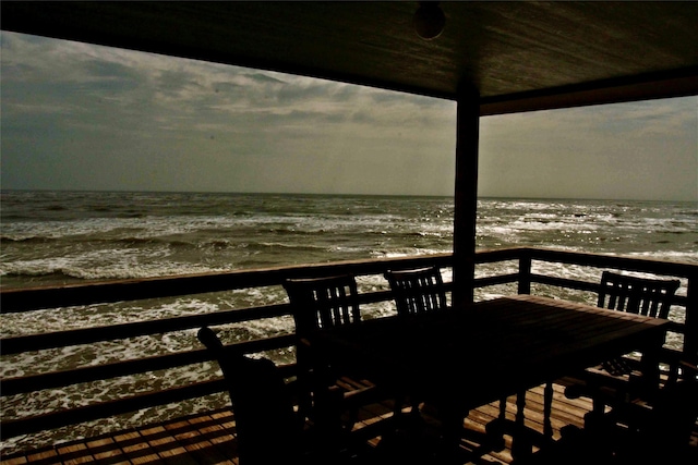 13015 Gulf Beach Dr, Freeport, TX 77541 - wooden deck featuring view of water and beach and outdoor dining area