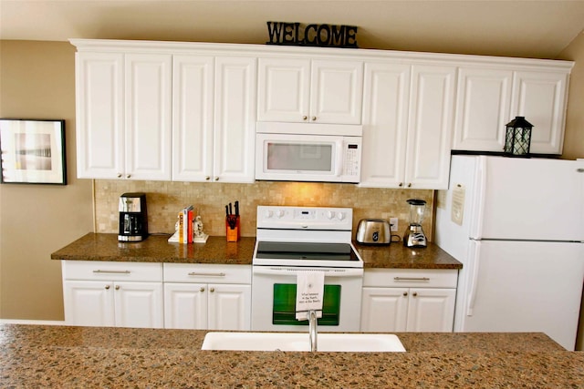 13015 Gulf Beach Dr, Freeport, TX 77541 - kitchen featuring white appliances, white cabinetry, and dark stone countertops