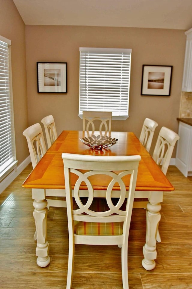 13015 Gulf Beach Dr, Freeport, TX 77541 - dining area with light wood-style flooring and baseboards