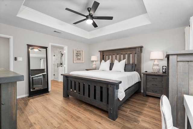 21343 Slate Crossing Ln, Katy, TX 77449 - bedroom with a raised ceiling, wood finished floors, crown molding, a ceiling fan, and ensuite bath
