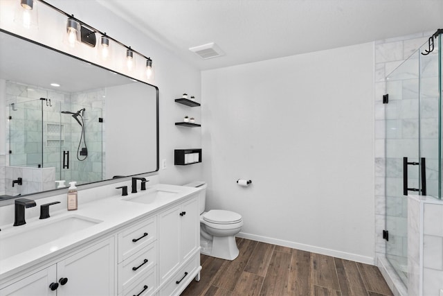 21343 Slate Crossing Ln, Katy, TX 77449 - full bathroom with double vanity, a shower stall, toilet, and wood finished floors