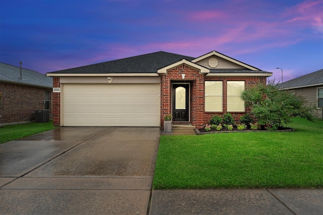 21343 Slate Crossing Ln, Katy, TX 77449 - single story home with concrete driveway, brick siding, a lawn, an attached garage, and a shingled roof