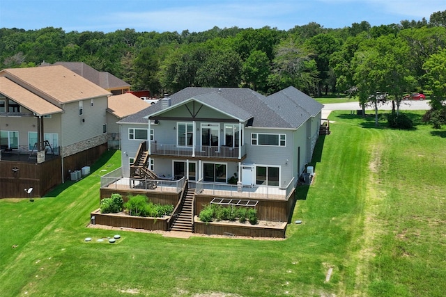 230 Legacy Blvd, Point Blank, TX 77364 - back of house featuring stairway, a balcony, a lawn, a shingled roof, and a view of trees