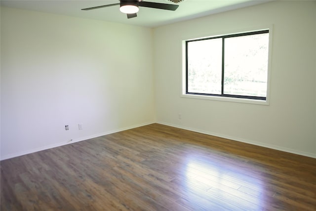 1803 Hickory Ln, Brenham, TX 77833 - empty room with a ceiling fan, dark wood-style floors, and baseboards
