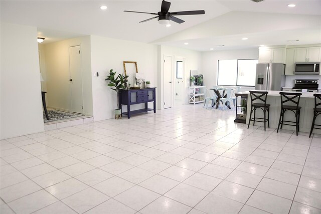 1803 Hickory Ln, Brenham, TX 77833 - living room with a ceiling fan, lofted ceiling, recessed lighting, and light tile patterned floors